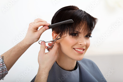 Hairdresser doing Hairstyle. Brunette with Short Hair 