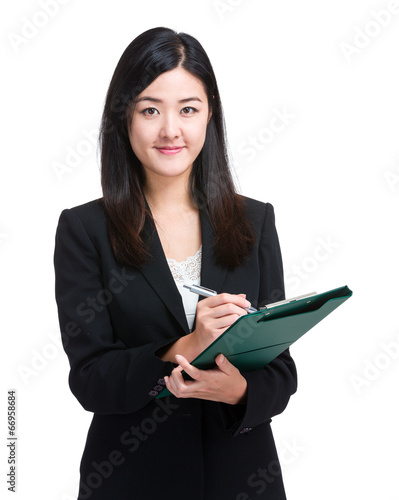 Business woman jot something on file pad