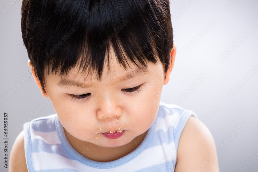 Baby boy with dirty mouth and look down Baby boy with dirty mouth and look down