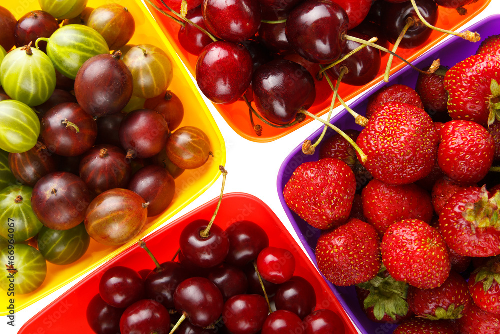 colored berries in bowls and white background colored berries in bowls and white background