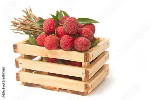 Fresh lychees with leaves in crate