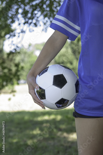 backside female holding a soccer ball © dukibu