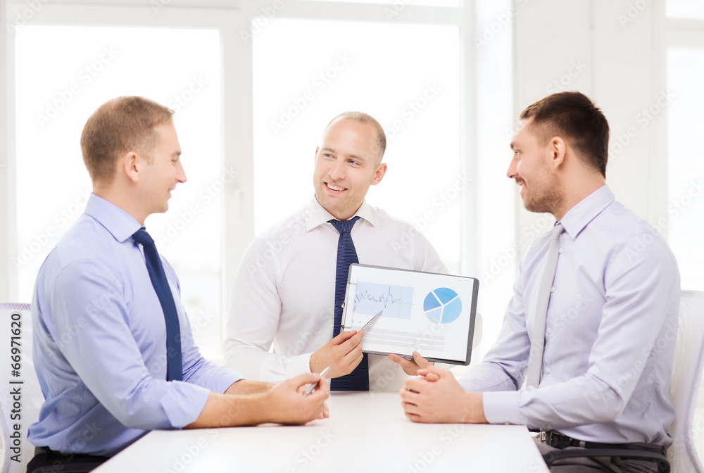 Fototapeta premium smiling businessmen with papers in office