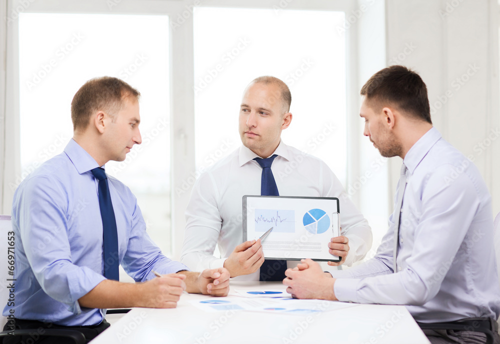 serious businessmen with papers in office serious businessmen with papers in office