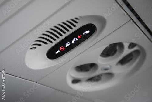 no smoking sign and fasten seat belts sign in plane
