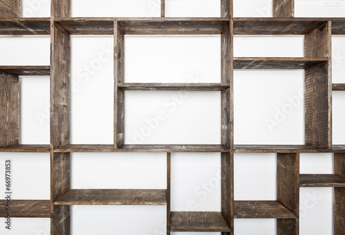 Rustic style shelves on white wall photo