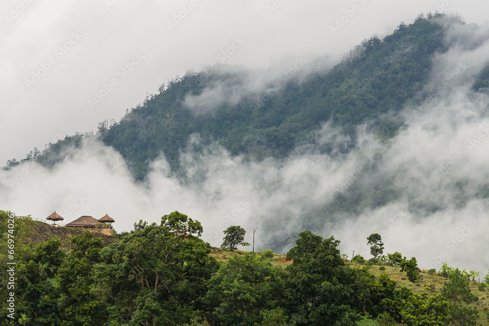 small house on mountain with fog and cloud