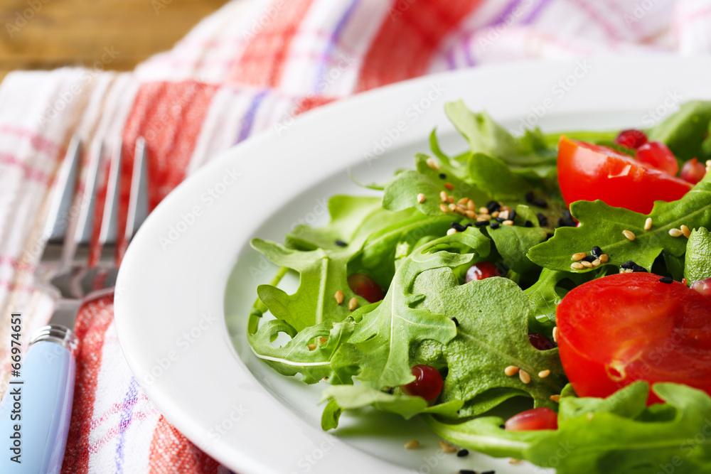 Green salad made with arugula, tomatoes and sesame Green salad made with arugula, tomatoes and sesame