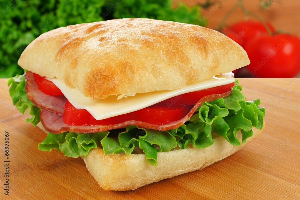Ciabatta sandwich with ham, cheese, lettuce and tomato Ciabatta sandwich with ham, cheese, lettuce and tomato