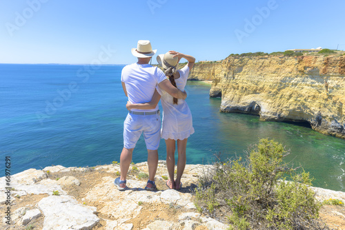 Couple enjoying the ocean view from a cliff