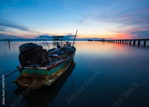 fishing boat in the sea at sunset