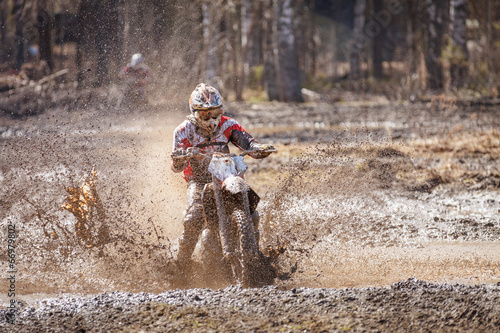 Motocross driver in mud