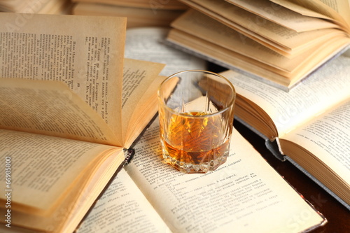 Glass of whiskey on books photo