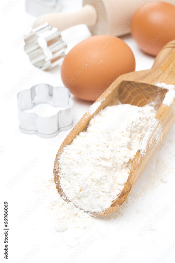 scoop with wheat flour, eggs and cookie cutters isolated scoop with wheat flour, eggs and cookie cutters isolated