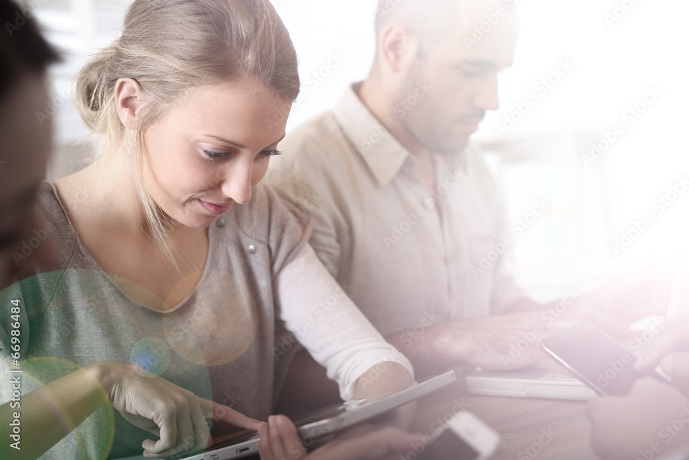 Group of business people using electronic devices at work Group of business people using electronic devices at work