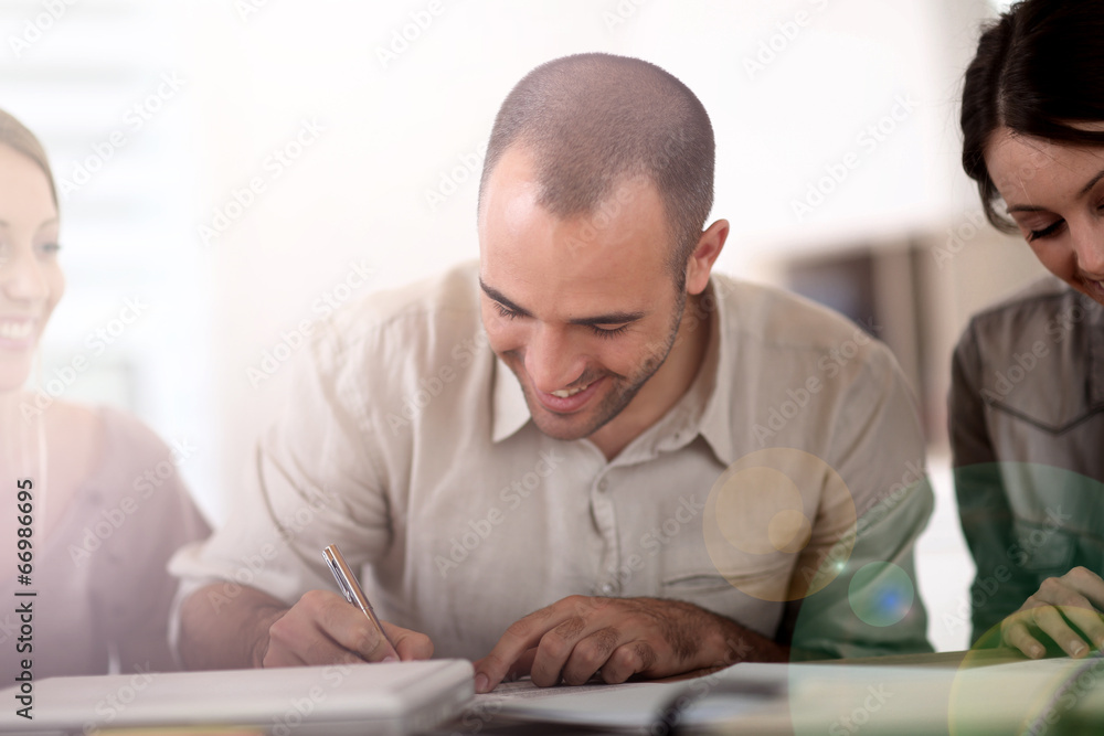 Portrait of young man filling in application form