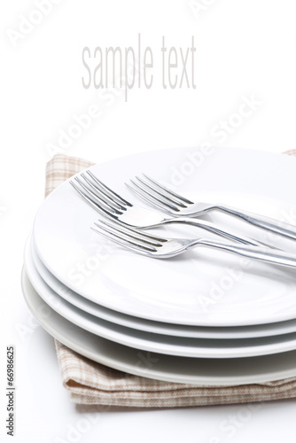 tableware for dinner - plates and forks, isolated on white