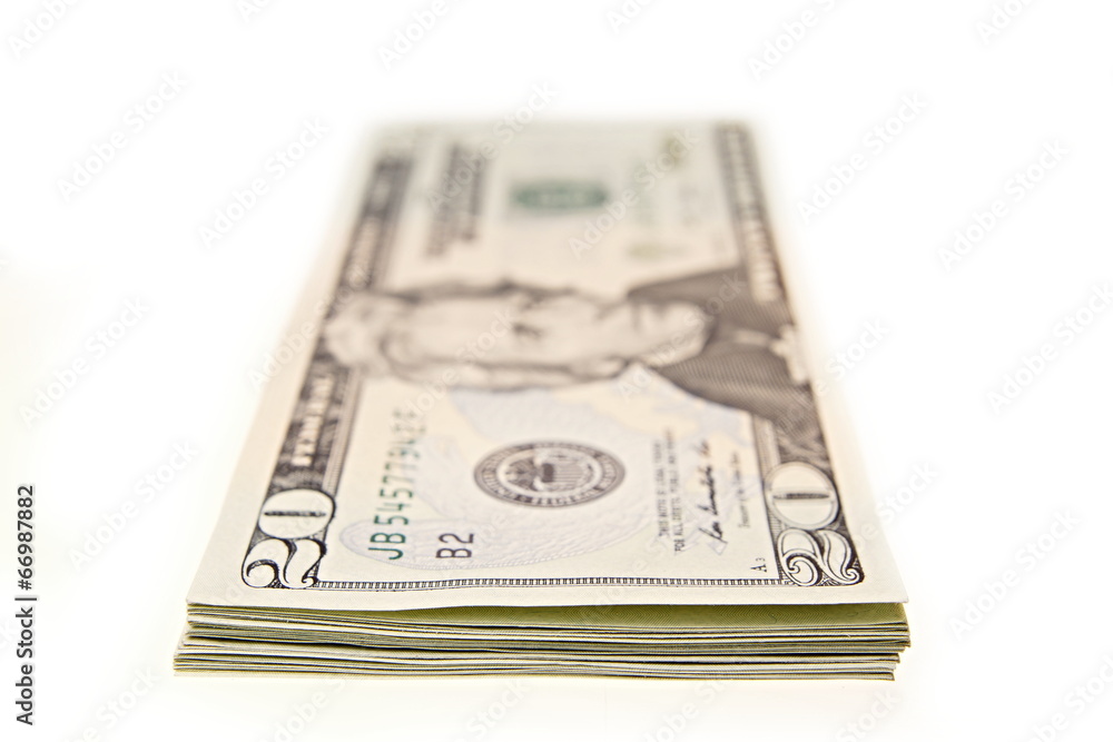 Bundle of twenty dollar bills lying on the table Bundle of twenty dollar bills lying on the table