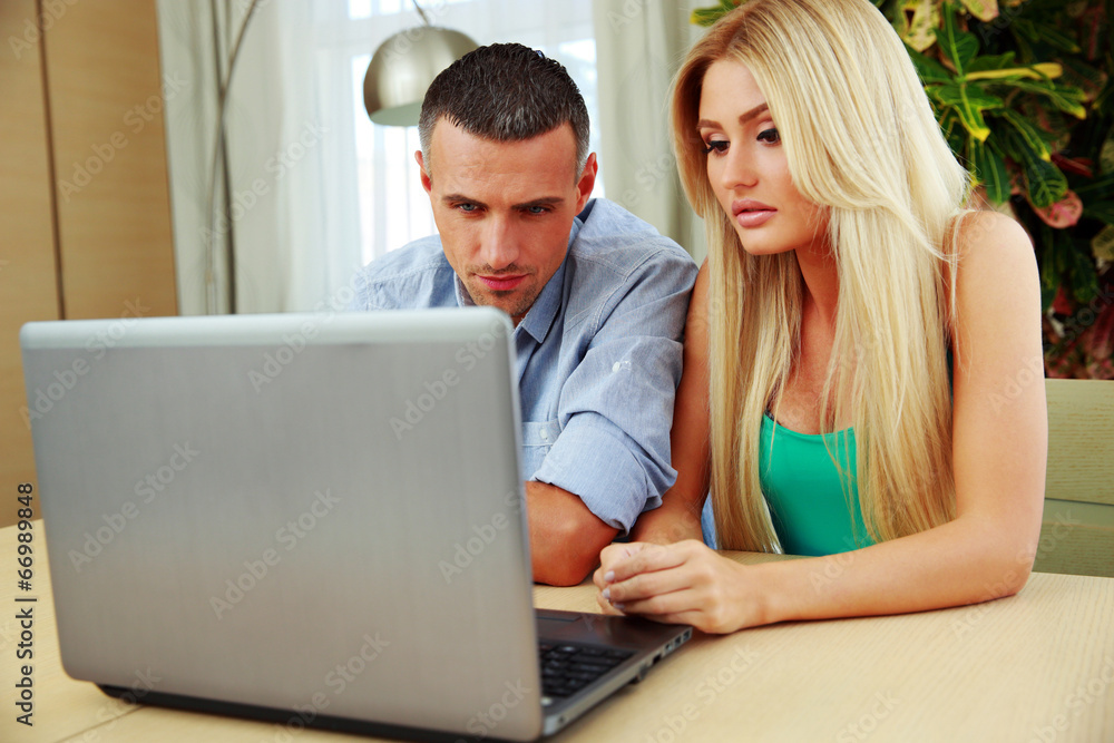 Young couple using laptop together