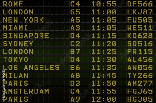 Black airport departures board with yellow text © WavebreakMediaMicro