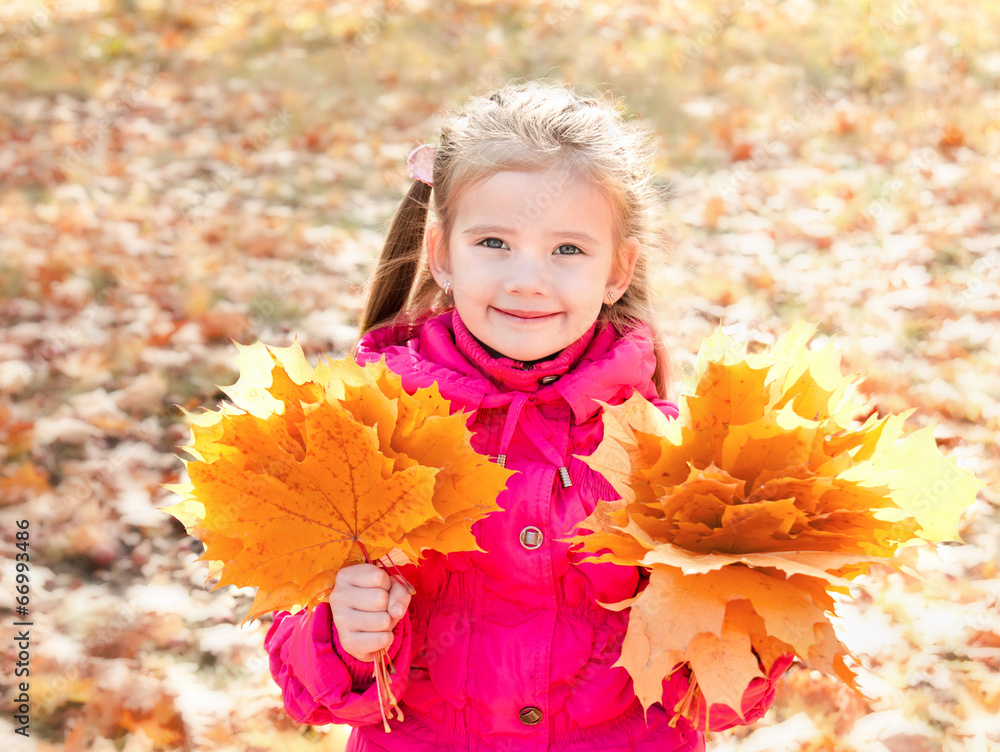 Autumn portrait of cute smiling little girl with maple leaves Autumn portrait of cute smiling little girl with maple leaves