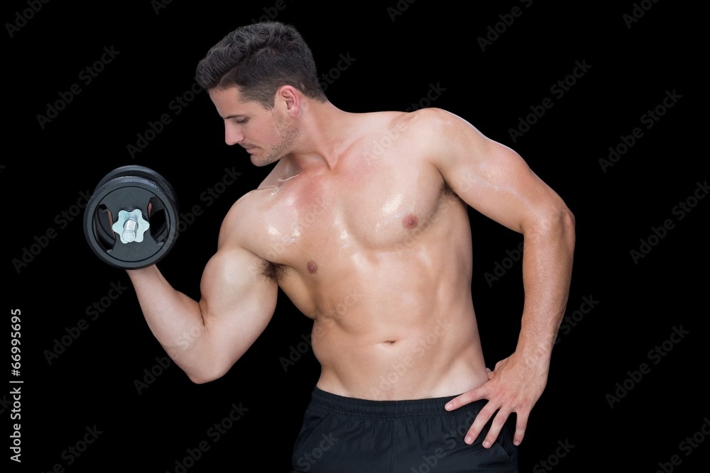 Strong crossfitter lifting up heavy dumbbell