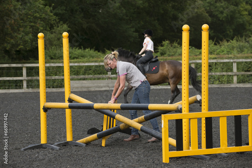 Building a jump for ponies and horses in a riding school