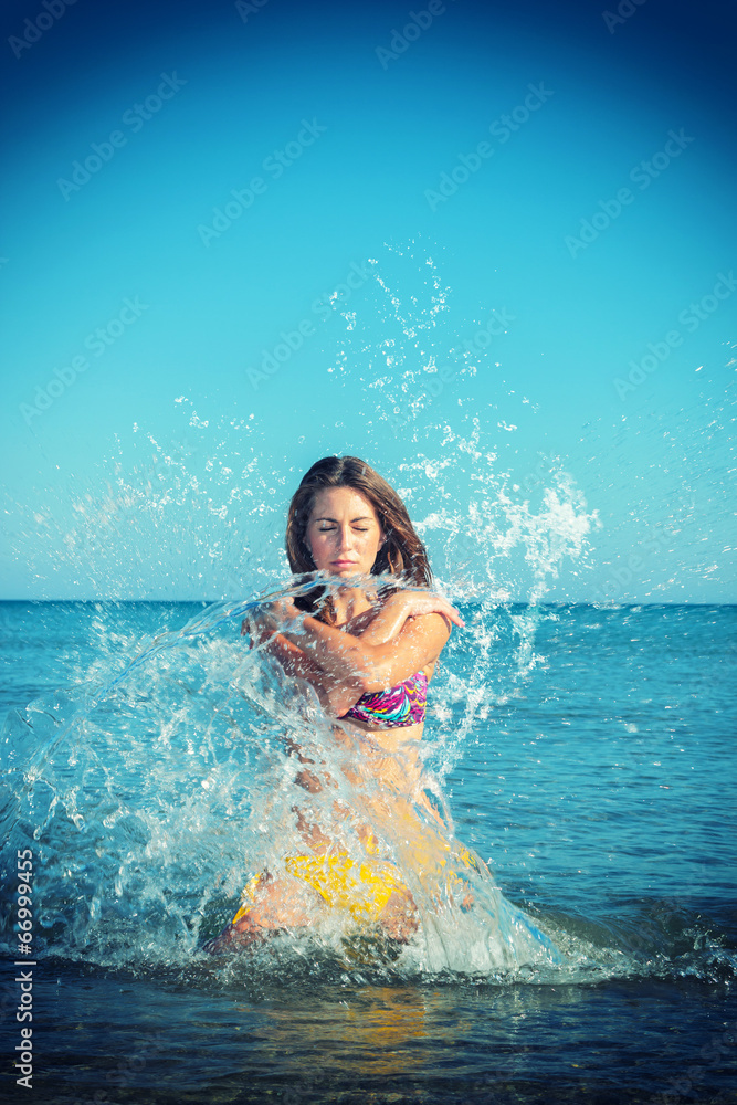 Beautiful woman jumps out of the sea  big splash