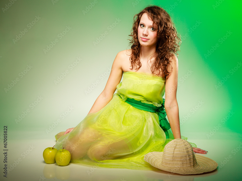 Φωτογραφία Spring or summer. Young woman girl in green dress sitting