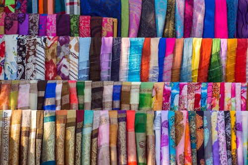 Various of colorful fabrics and shawls at a market stall