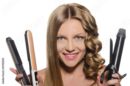 Woman holds curling iron photo