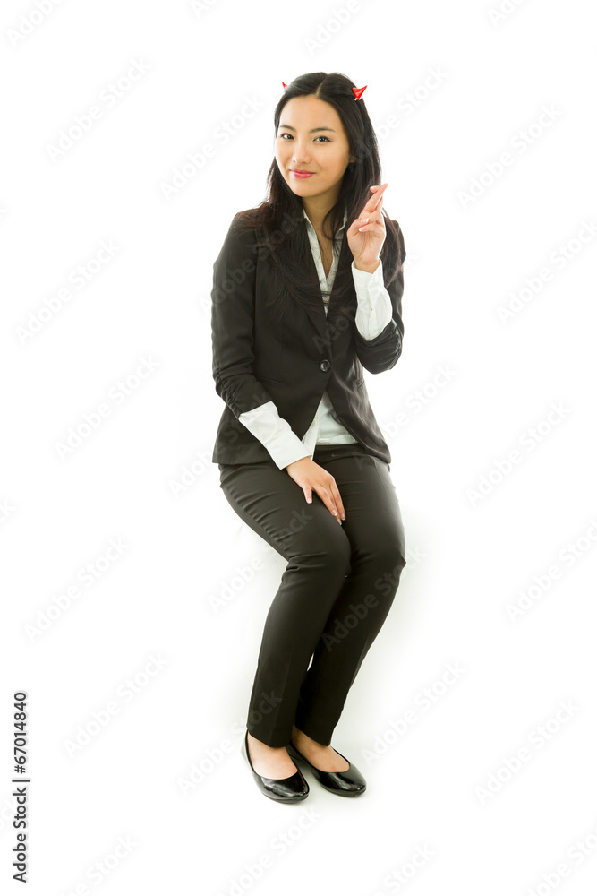 Asian young businesswoman sitting on stool in devil horns with Asian young businesswoman sitting on stool in devil horns with