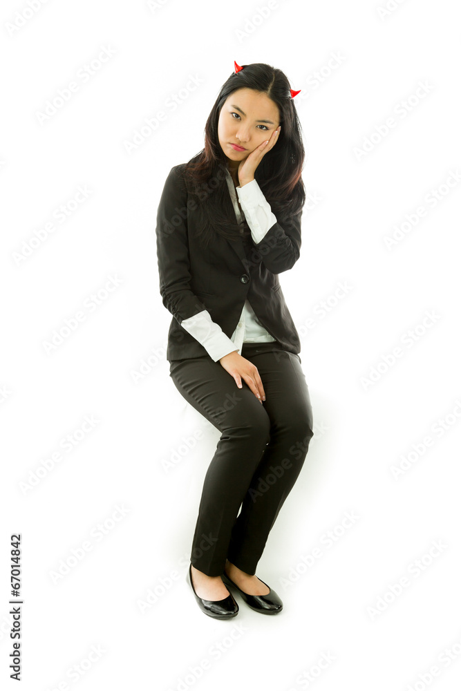 Asian young businesswoman sitting on stool in devil horns Asian young businesswoman sitting on stool in devil horns