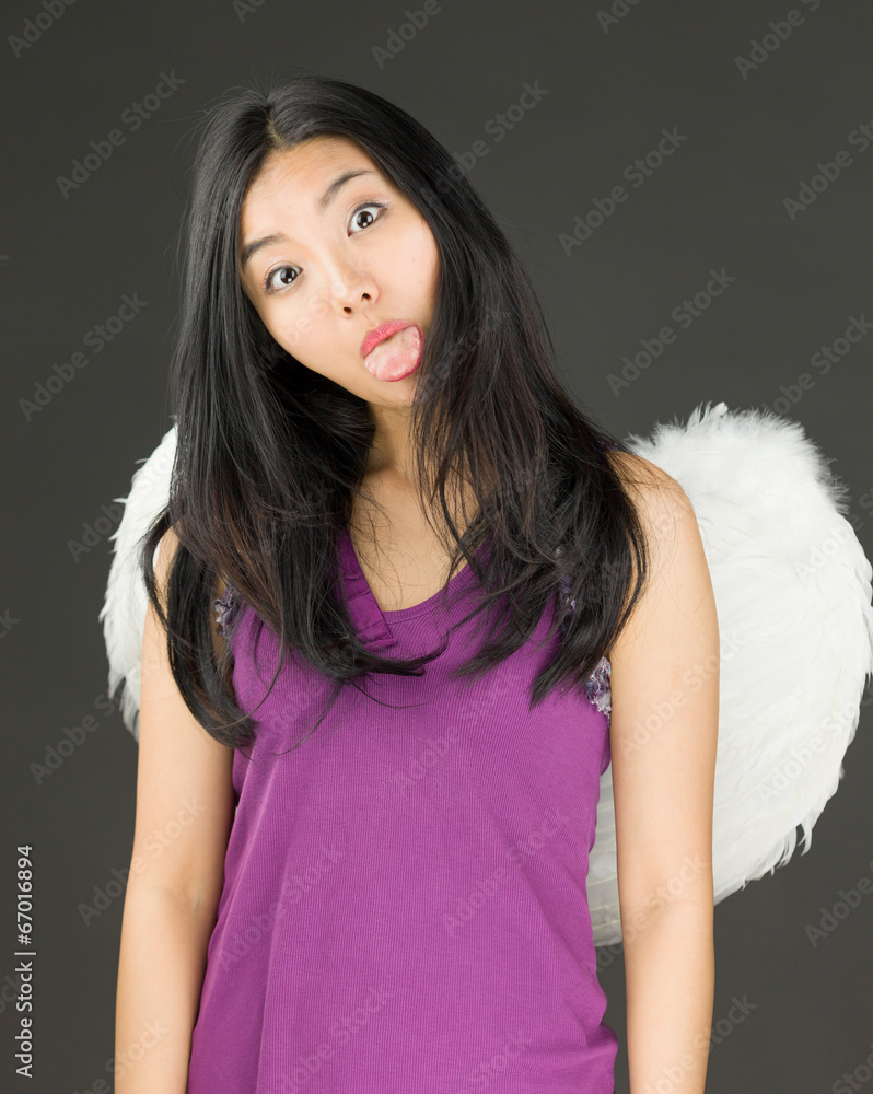 Angel side of a young Asian woman sticking out her tongue and Stock Photo | Adobe Stock Angel side of a young Asian woman sticking out her tongue and Stock Photo | Adobe Stock