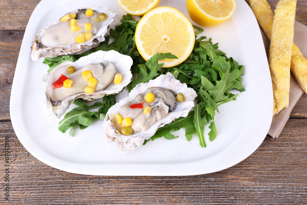 Tasty cooked oysters in shell on wooden table Tasty cooked oysters in shell on wooden table