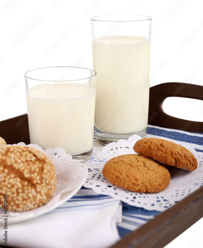 Milk and cookies on wooden tray isolated on white Milk and cookies on wooden tray isolated on white