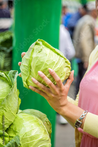 Woman buying vegetables on ...