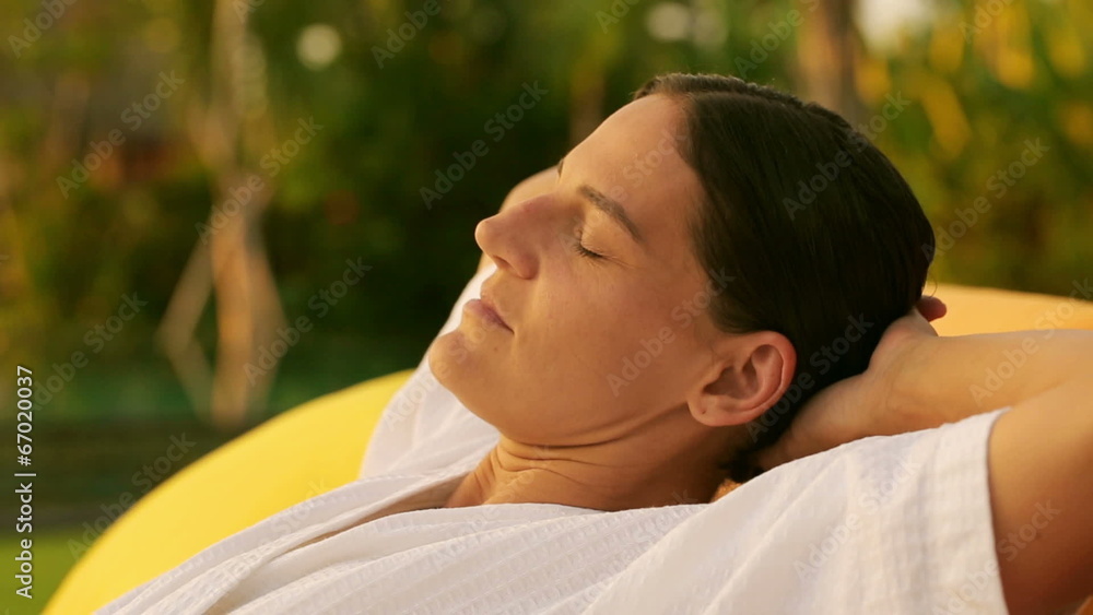 Woman resting and lying in exotic garden, steadycam shot Woman resting and lying in exotic garden, steadycam shot