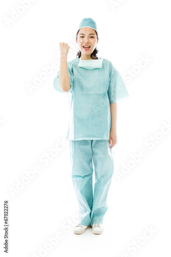 Asian female surgeon punches fist into the air isolated on white