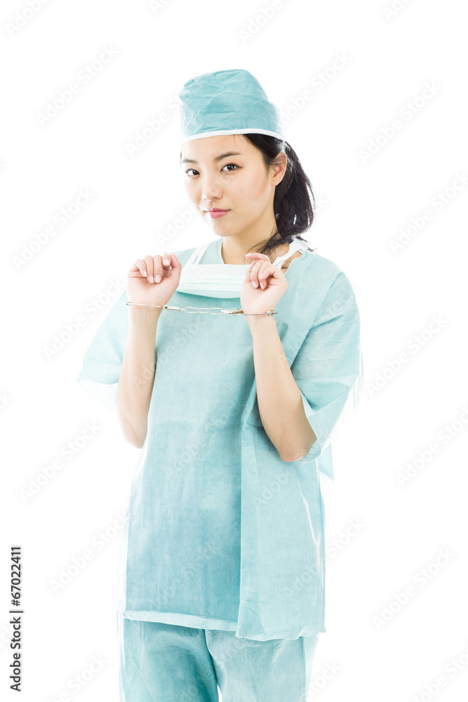 Asian female surgeon in blue uniform with handcuffed hands Asian female surgeon in blue uniform with handcuffed hands