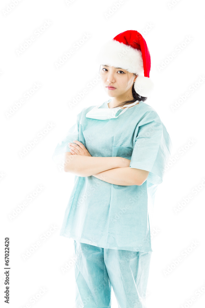 Upset Asian female surgeon wearing Santa hat Upset Asian female surgeon wearing Santa hat