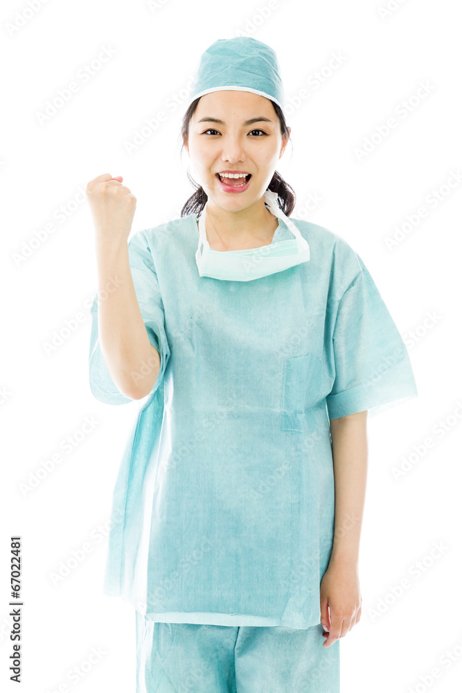 Asian female surgeon punches fist into the air isolated on white Asian female surgeon punches fist into the air isolated on white