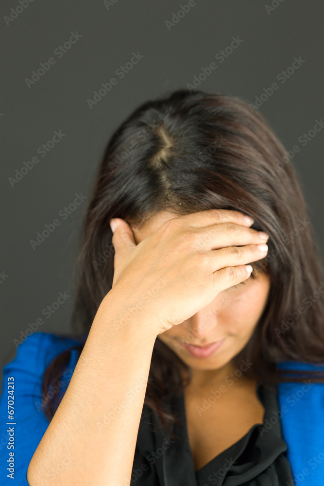 Upset young businesswoman with her head in hands Upset young businesswoman with her head in hands