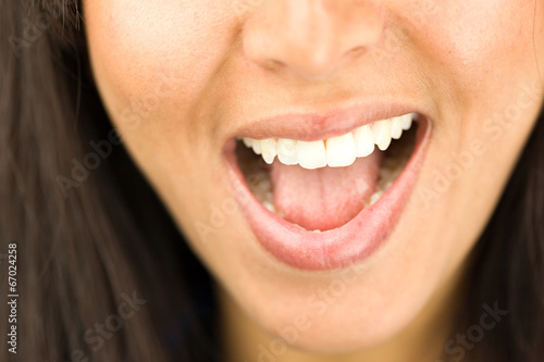Extreme close-up of a young woman laughing