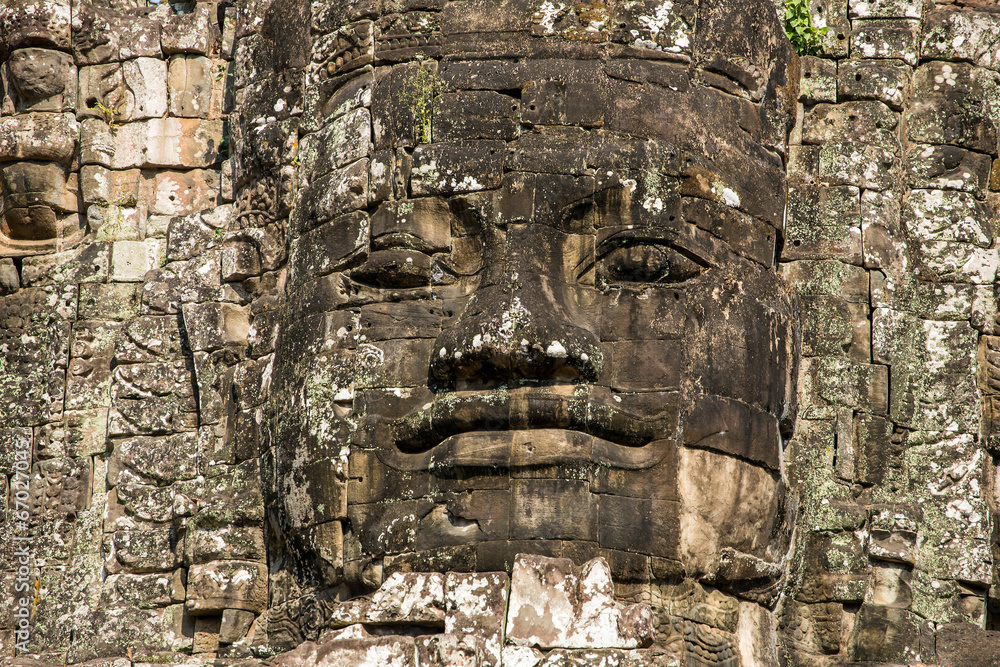 Stone faces on the towers of ancient Bayon Temple in Angkor Thom