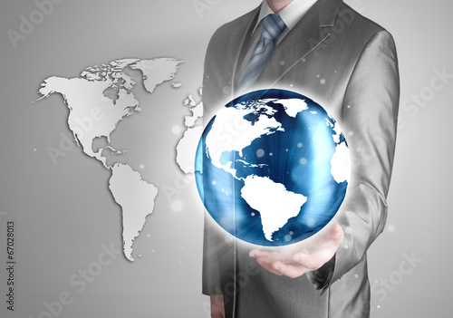 Businessman holds Earth in a hand