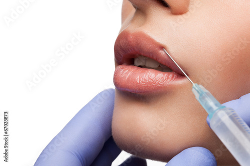 Cosmetic injection in woman's lip photo