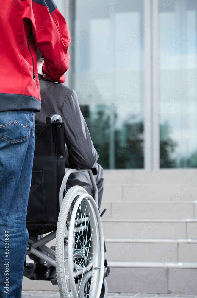 Obraz premium Man on wheelchair before work