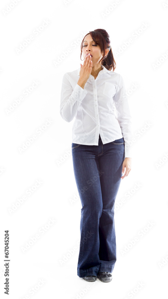 Indian young woman yawning with hand over mouth Indian young woman yawning with hand over mouth