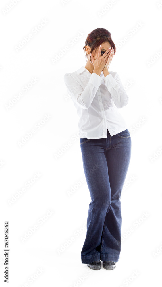 Indian young woman peeking through fingers Indian young woman peeking through fingers